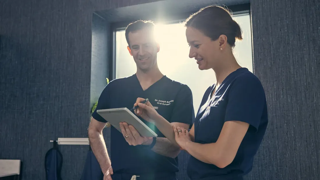 Two clinicians reviewing results on a tablet, from a Thrill Wave shoot