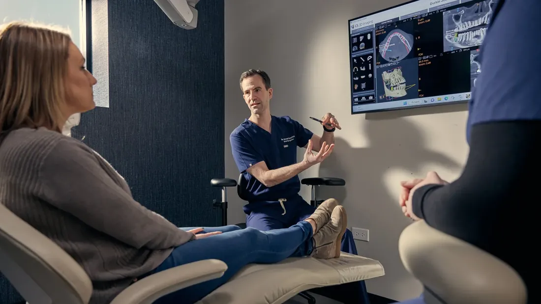 A doctor walking a patient through scans on a screen, from a Thrill Wave shoot